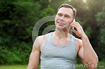 Man stands with a telephone in the park