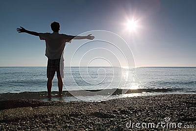 Man stands in water and conducts hands in sides