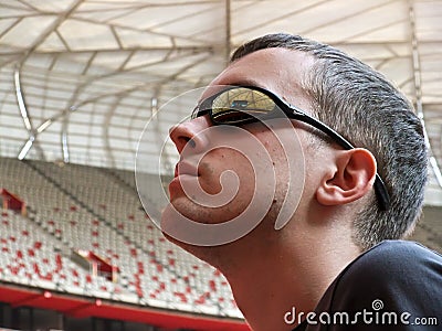 Man staring up at stadium roof