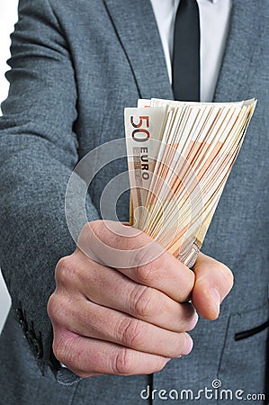 Man in suit with a wad of euro bills