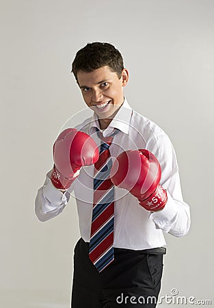 Man in suit wearing boxing gloves