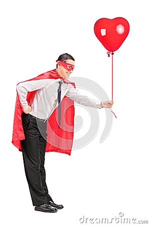 Man in superhero costume holding a red balloon