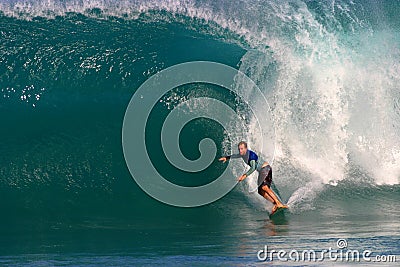 A Man Surfing a Blue Wave in Hawaii