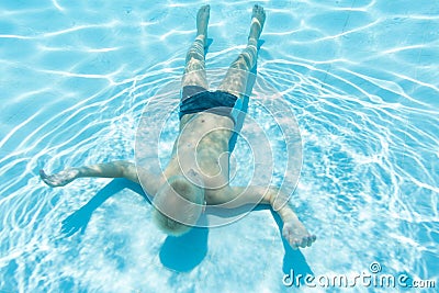 Man swims under water face up