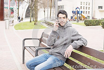 Man talking on the phone in the street.