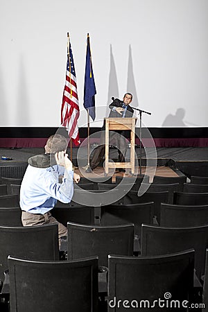 Man throwing shoe at person on stage