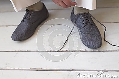 Man ties his shoes