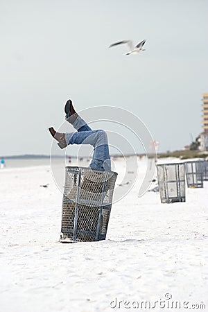 Man in Trash on Beach
