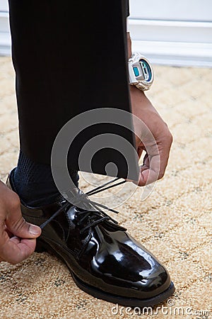 Man Tying Shoe Laces on Black Dress Shoes