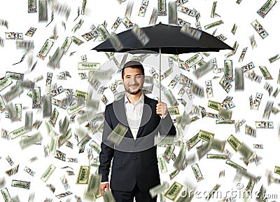 Man with umbrella standing under money rain