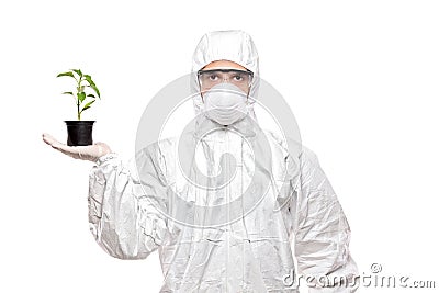 A man in uniform holding a plant