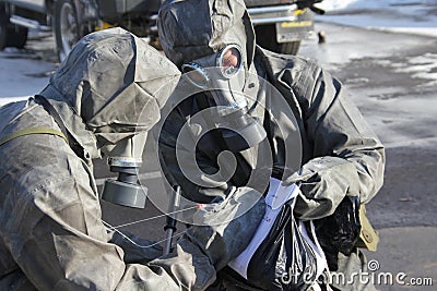 Man in uniform marking a black garbage bag