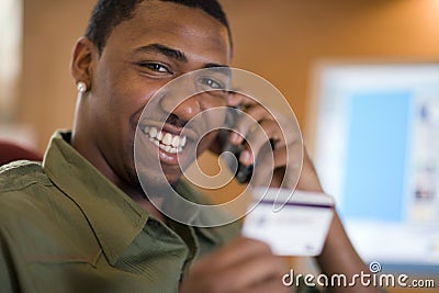 Man using credit card and cell phone