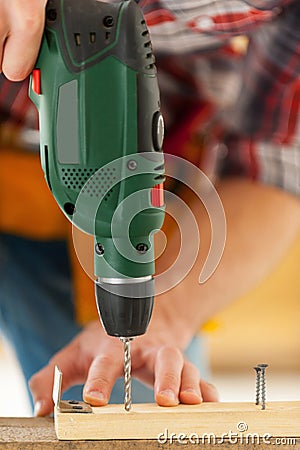 Man using drill.