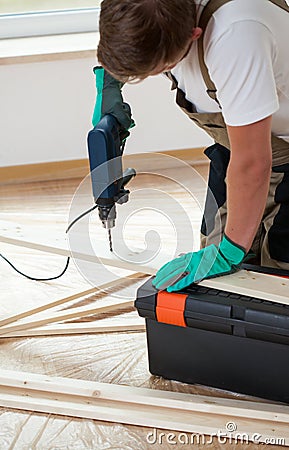 Man using electric drill at home