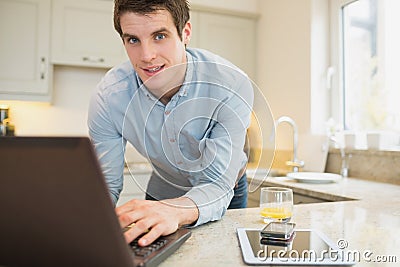 Man using laptop wirth smartphone and tablet