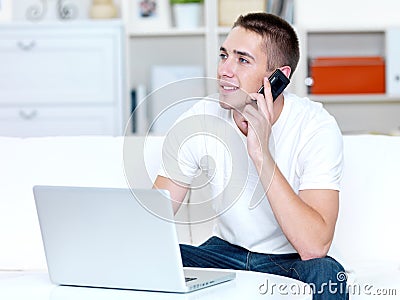 Man using mobile phone and laptop