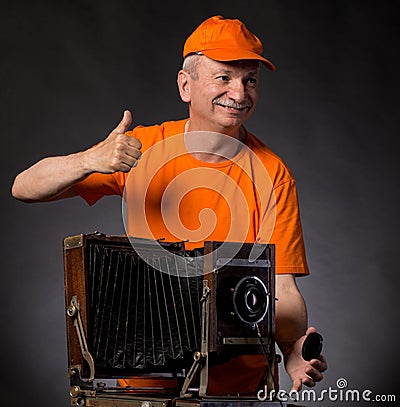 Man with vintage wooden camera