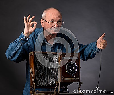 Man with vintage wooden photo camera