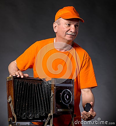 Man with vintage wooden photo camera