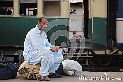 Man waits at station, trains delayed.