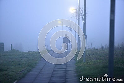 Man walking alone in foggy weather