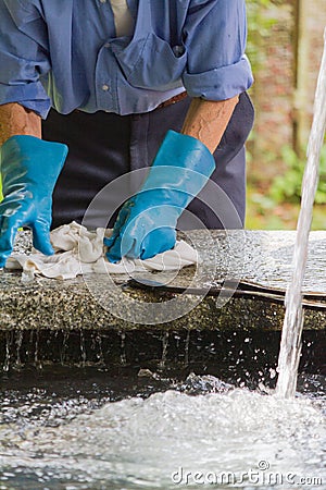 Man washing clothes the old fountain