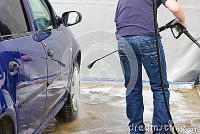 Man washing his car at self-service station