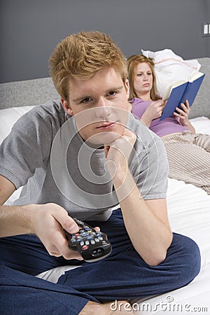 Man Watching TV In Bedroom