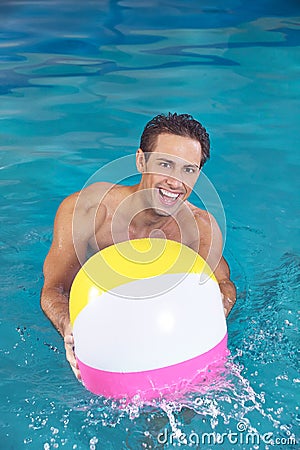 Man with water ball playing in pool