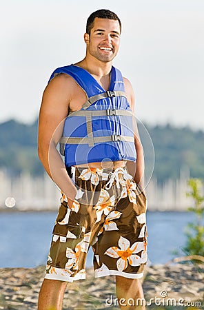 Man wearing life jacket at beach