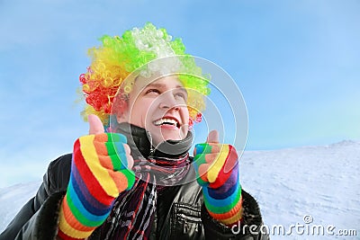 Man in wig of clown looks in sky