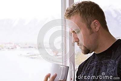 Man by the Window with a Cup of Coffee
