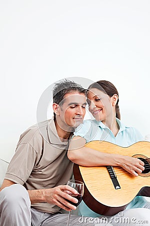 Man with wine and woman with guitar