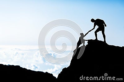 Man and woman help silhouette in mountains