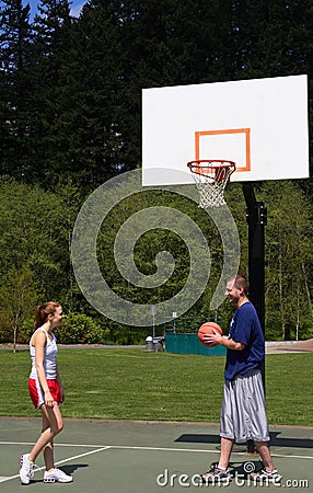 Man and woman playing basketball