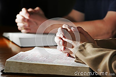 Man & Woman Praying Bibles