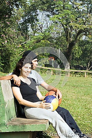 Man and Woman Sitting on a Park Bench - Vertical