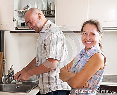 Man and woman washing dishes