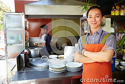 Man working as cook in Asian restaurant kitchen