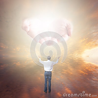 Man worshiping God. Hands with light coming from the sky
