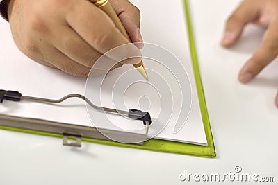 Man writing on blank paper on clipboard. You can put your design on it ...