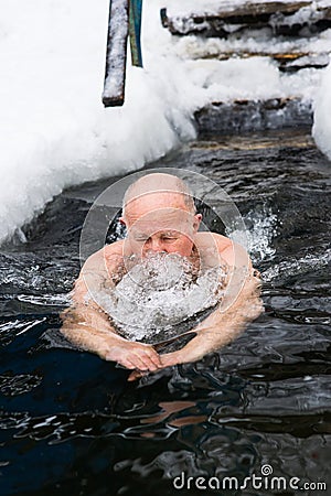 A man in years swims in the ice hole