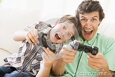 Man and young boy with video game controllers