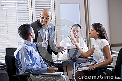 Manager meeting with office workers, directing