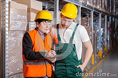 Manager and worker in warehouse