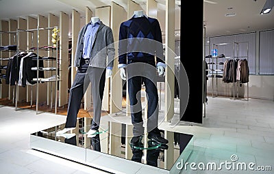 Manneqiuns in section of men clothes in shop