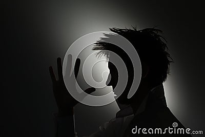 Mans face silhouette with hand.