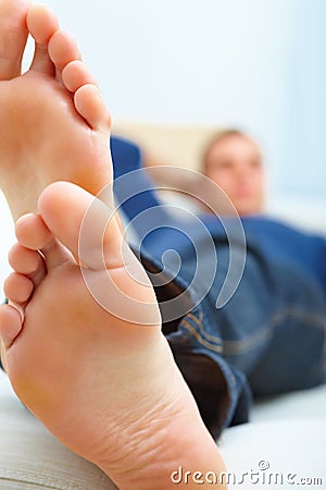 Sofa Feet on Mans Feet Resting At Home On The Couch Stock Photo   Image  6985150
