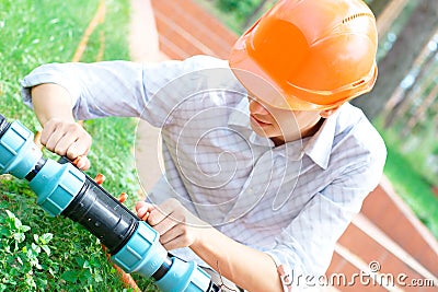 Manual worker repairing a pipe